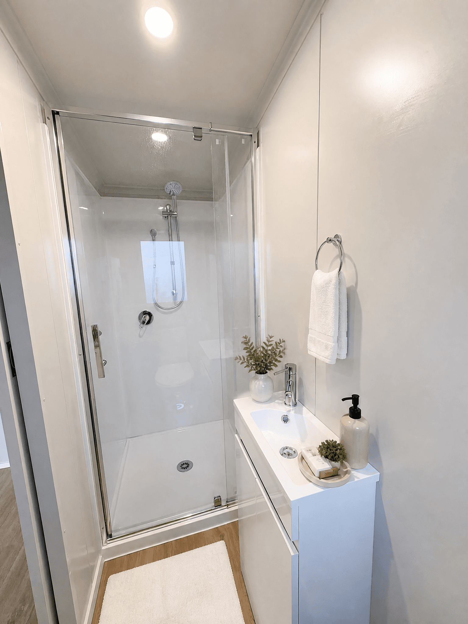 5.4×2.7 granny flat tiny home bathroom render — glass shower and vanity