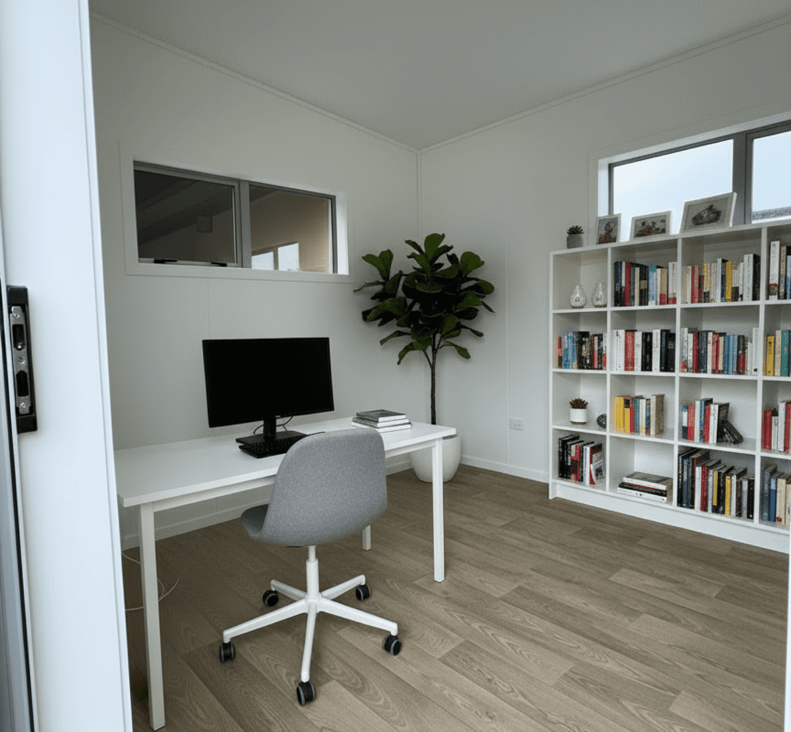 Open cabin interior with double-glazed window and timber-look flooring