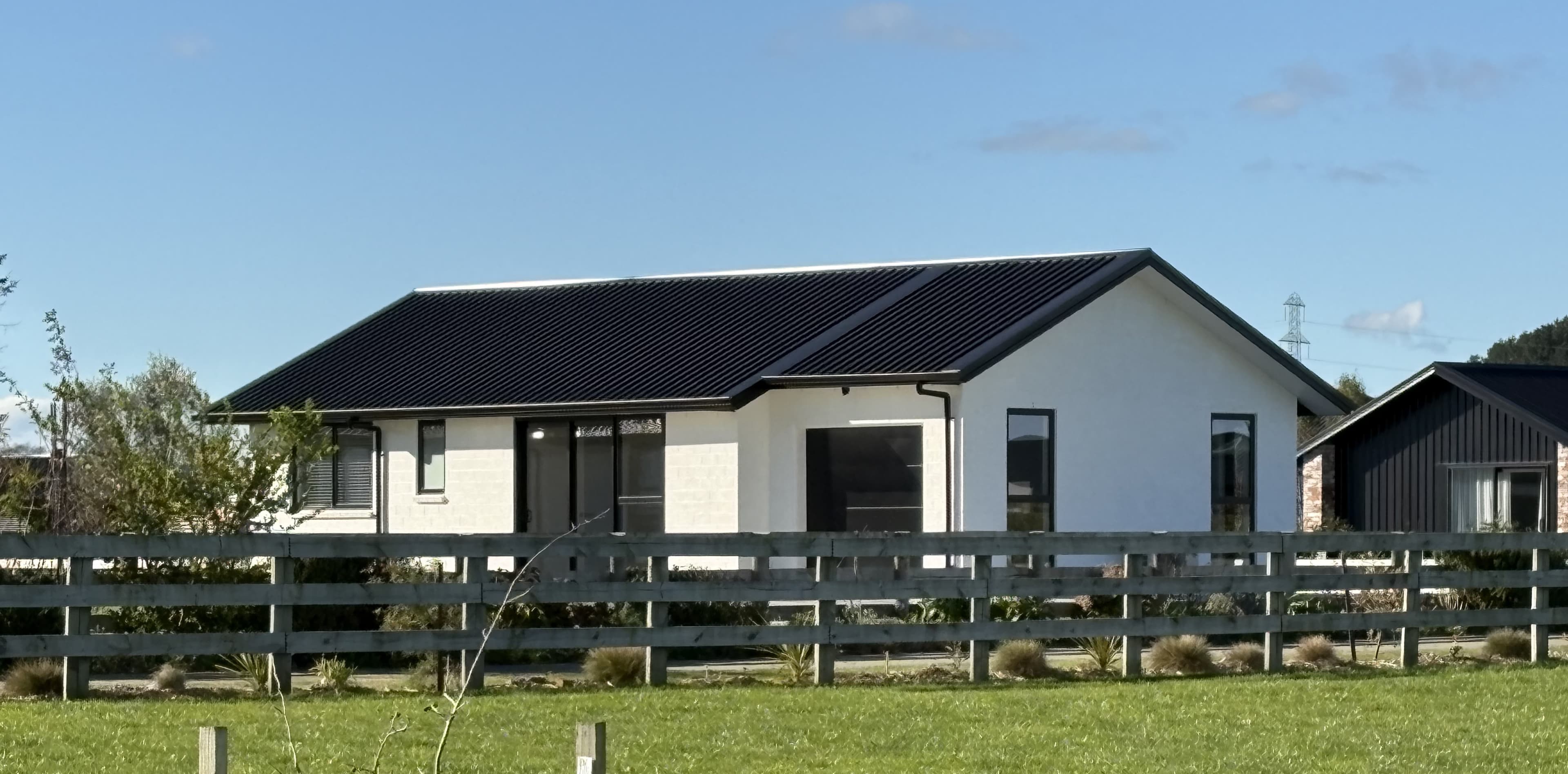 White gable-roof NZ-made transportable family home on a Pirongia lifestyle section