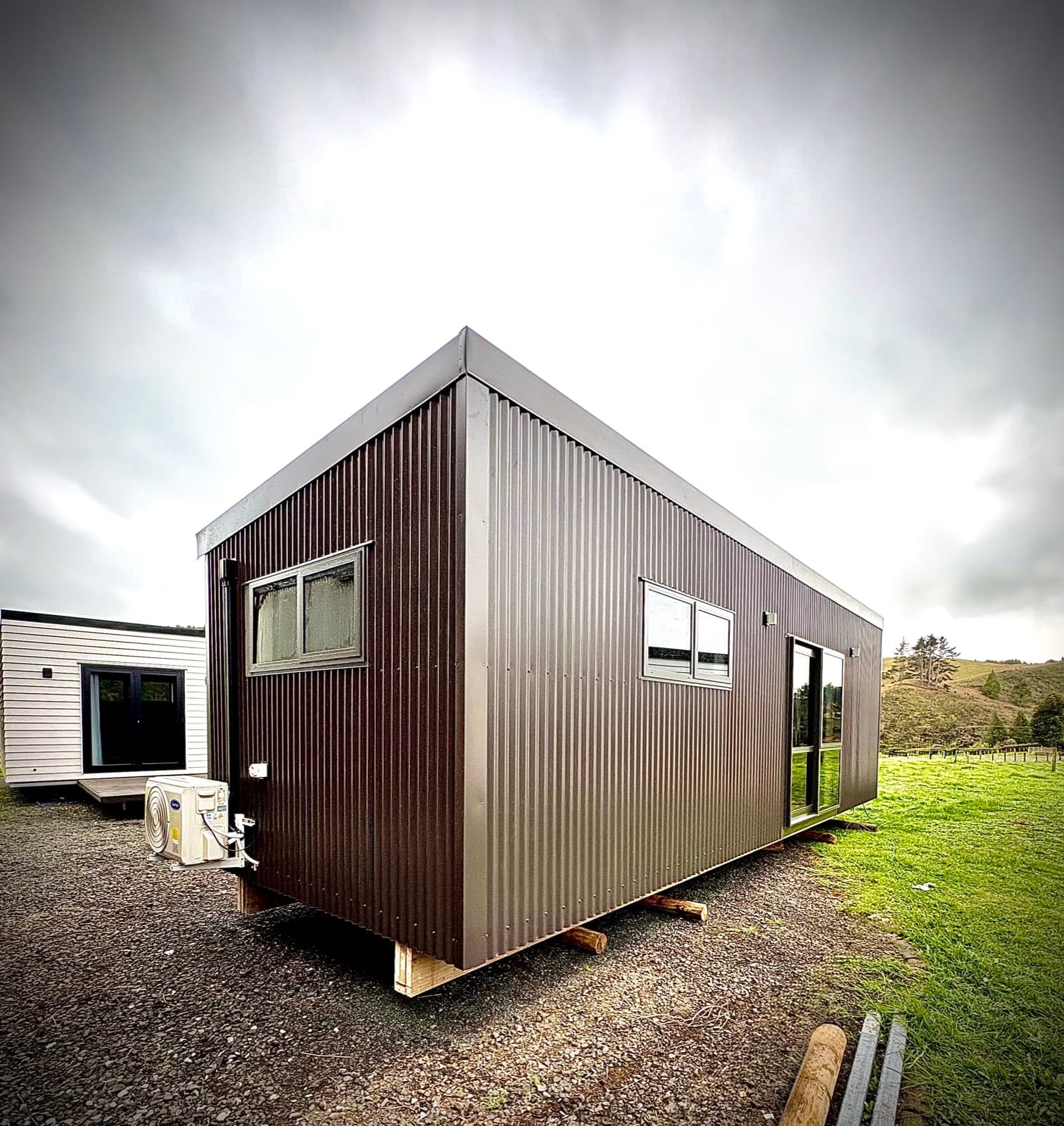 Custom 9m × 3m tiny home with heat pump and Coloursteel® exterior