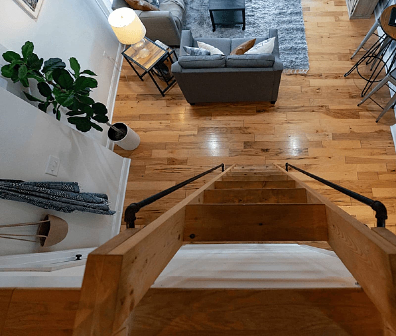 Open-plan tiny home interior with kitchen and breakfast bar